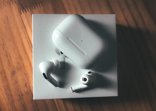A pair or white Airpods with the case, on top of the box